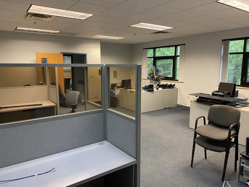 Office filled with cubicles and furniture before cleanout