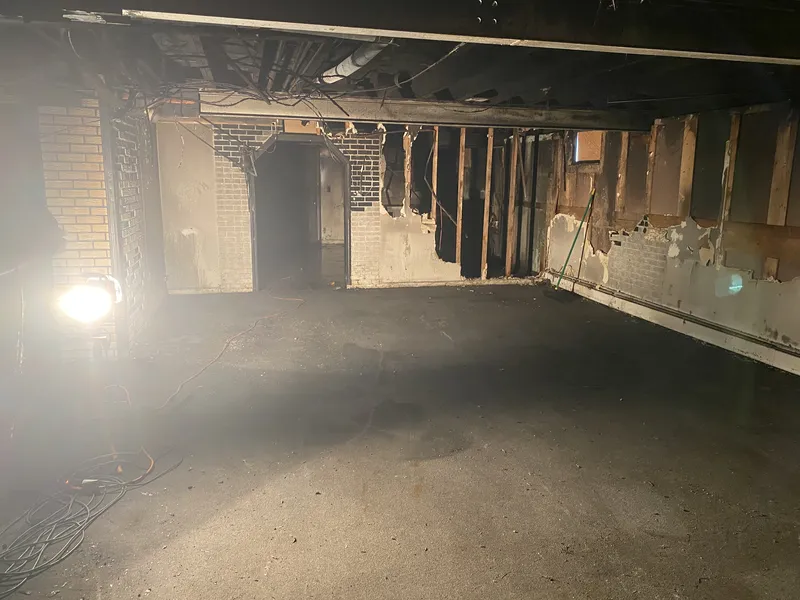 Basement cleared revealing exposed brick walls