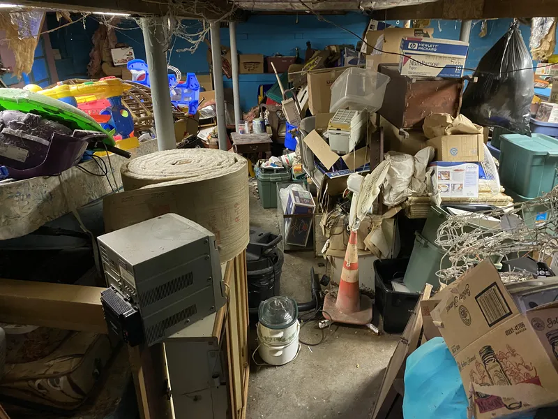 Basement overflowing with hoarded items and old equipment
