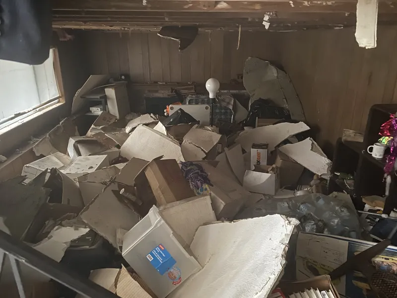 Room filled with collapsed boxes and discarded items