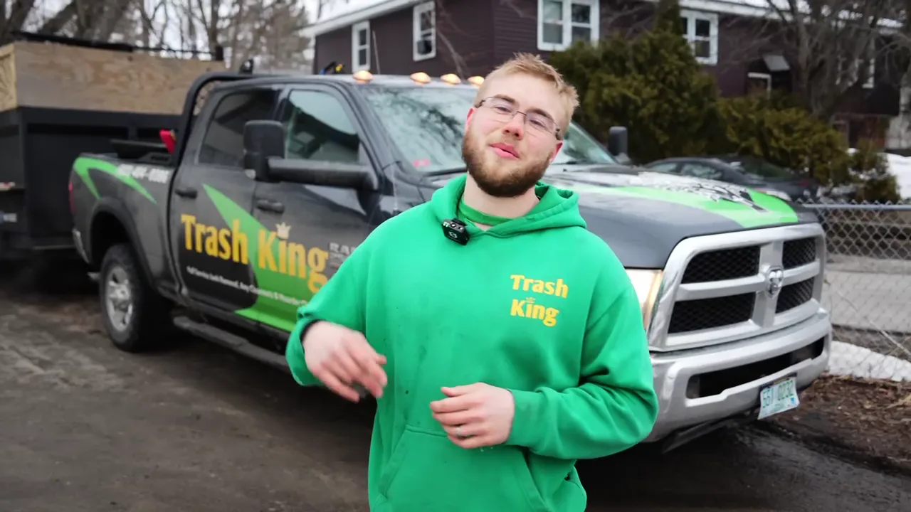 Trash King owner introducing the company in front of the branded truck and trailer